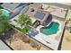 Aerial view of a home with a pool, solar panels, covered patio, and palm trees at 207 E Strahan Dr, Tempe, AZ 85283