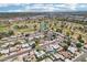 Aerial view showcasing the neighborhood, featuring a nearby golf course and multiple ponds at 207 E Strahan Dr, Tempe, AZ 85283