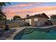 Relaxing backyard with a sparkling pool, covered patio, and a fenced area, perfect for outdoor enjoyment at 207 E Strahan Dr, Tempe, AZ 85283