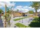 Backyard featuring artificial grass, patio, and dog agility equipment at 207 E Strahan Dr, Tempe, AZ 85283