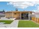 This home features a covered patio with a grass backyard and custom stone walkway at 207 E Strahan Dr, Tempe, AZ 85283