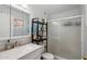 Bathroom features a sink, vanity, toilet, shower, and toiletries on shelving at 207 E Strahan Dr, Tempe, AZ 85283