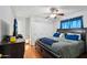 Spacious bedroom with hardwood floors, ceiling fan, closet, and large bed at 207 E Strahan Dr, Tempe, AZ 85283
