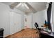 Bedroom features hardwood floors, a ceiling fan, a large closet, a window, and a desk at 207 E Strahan Dr, Tempe, AZ 85283