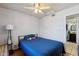 Bedroom features hardwood floors, a ceiling fan, a window for natural light, and neutral walls at 207 E Strahan Dr, Tempe, AZ 85283