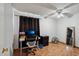 Bedroom features hardwood floors, a ceiling fan, a window, a desk, and a mirror at 207 E Strahan Dr, Tempe, AZ 85283