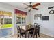 Cozy dining area featuring a wooden table, ceiling fan, and bright window, perfect for Gathering meals at 207 E Strahan Dr, Tempe, AZ 85283