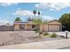 Charming house features desert landscaping, and a two-car garage at 207 E Strahan Dr, Tempe, AZ 85283