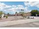 Single story home with low maintenance desert landscaping, a two-car garage, and mature landscaping at 207 E Strahan Dr, Tempe, AZ 85283