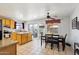 Bright kitchen with a tile floor, an island with granite countertops, and sliding glass doors leading to the backyard at 207 E Strahan Dr, Tempe, AZ 85283