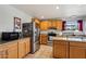 Bright kitchen featuring stainless steel appliances, granite countertops, and light wood cabinets at 207 E Strahan Dr, Tempe, AZ 85283
