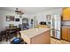 Bright kitchen with stainless steel appliances, tile floors, and granite countertops on the island at 207 E Strahan Dr, Tempe, AZ 85283