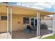 Covered patio with outdoor seating overlooking the backyard and grilling area at 207 E Strahan Dr, Tempe, AZ 85283