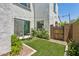 Charming backyard featuring artificial turf, patio seating, mature landscaping, and private gate at 22306 N 34Th Pl, Phoenix, AZ 85050