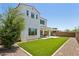 Spacious backyard features a covered patio, artificial turf, and gravel accents on a sunny day at 22306 N 34Th Pl, Phoenix, AZ 85050