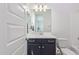 Bathroom featuring single vanity with dark cabinets, a mirror and a toilet at 22306 N 34Th Pl, Phoenix, AZ 85050