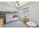 Bright bedroom with a bunk bed, desk area, and a large window at 22306 N 34Th Pl, Phoenix, AZ 85050
