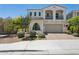 Charming two-story home featuring a balcony, arched windows, and a well-maintained front yard at 22306 N 34Th Pl, Phoenix, AZ 85050