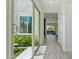 Bright hallway with wood-look tile floors leading to a view of the backyard patio at 22306 N 34Th Pl, Phoenix, AZ 85050