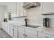 This kitchen boasts white cabinets, marble countertops, and stainless steel appliances at 22306 N 34Th Pl, Phoenix, AZ 85050