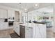 Open kitchen showcases stainless steel appliances, white cabinets, and a breakfast bar at 22306 N 34Th Pl, Phoenix, AZ 85050