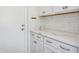 Kitchen with white cabinets, marble countertops, and stainless steel hardware at 22306 N 34Th Pl, Phoenix, AZ 85050