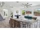 Airy living room boasts neutral decor, wood-look floors, ceiling fan, and large windows at 22306 N 34Th Pl, Phoenix, AZ 85050