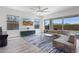 Spacious living room with backyard views, tile flooring, and comfortable sectional sofa at 22306 N 34Th Pl, Phoenix, AZ 85050