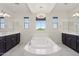 Bright main bathroom showcasing a soaking tub with elegant fixtures and a tranquil ambiance at 22306 N 34Th Pl, Phoenix, AZ 85050