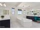 Luxurious main bathroom featuring a standalone tub, dual sinks, and lots of natural light at 22306 N 34Th Pl, Phoenix, AZ 85050