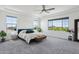 Main bedroom with neutral carpet, bright light, and plentiful windows showcasing views of the surroundings at 22306 N 34Th Pl, Phoenix, AZ 85050