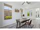 Home office with natural light, a rustic wood desk, mounted TV, and views of the lush outdoors at 22306 N 34Th Pl, Phoenix, AZ 85050