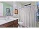 Clean bathroom features a single sink vanity, white shower curtain, and framed art at 25030 N 172Nd Ln, Surprise, AZ 85387