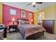 Cozy bedroom showcases a ceiling fan, carpeted floors, and a glimpse into the Primary bath at 25030 N 172Nd Ln, Surprise, AZ 85387