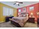 Comfortable bedroom featuring a ceiling fan, carpeted floors, and vibrant two-tone walls at 25030 N 172Nd Ln, Surprise, AZ 85387