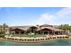Spacious community clubhouse with lake views, outdoor seating, and manicured lawn at 25030 N 172Nd Ln, Surprise, AZ 85387