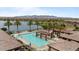 Resort-style pool and lounge area surrounded by lush landscaping, lake, and mountain views at 25030 N 172Nd Ln, Surprise, AZ 85387