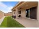 Inviting covered patio area featuring comfortable seating, a ceiling fan, and seamless indoor-outdoor living at 25030 N 172Nd Ln, Surprise, AZ 85387