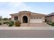 Charming single-story home featuring a stone entryway, two-car garage, and desert landscaping at 25030 N 172Nd Ln, Surprise, AZ 85387