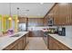 Open concept kitchen featuring stainless steel appliances, white countertops, and ample cabinet space at 25030 N 172Nd Ln, Surprise, AZ 85387