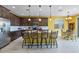 Well-appointed kitchen with a large island, pendant lighting, and a stainless steel refrigerator at 25030 N 172Nd Ln, Surprise, AZ 85387