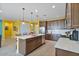 Modern kitchen with stainless steel appliances, a center island, and dark wood cabinets at 25030 N 172Nd Ln, Surprise, AZ 85387