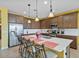 Spacious kitchen showcasing a central island with bar stools, stainless appliances, and pendant lighting at 25030 N 172Nd Ln, Surprise, AZ 85387