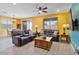Cozy living room featuring tile floors, comfortable sofas, and natural light at 25030 N 172Nd Ln, Surprise, AZ 85387