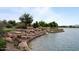 A scenic waterfall cascading into a serene lake, surrounded by lush greenery and rock formations at 25030 N 172Nd Ln, Surprise, AZ 85387