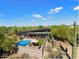 An elevated view of a modern desert home surrounded by mature landscaping and an in-ground pool at 25232 N Horseshoe Trl, Scottsdale, AZ 85255
