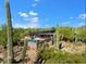 Enjoy an aerial view of a desert home boasting mature landscaping and an in-ground pool at 25232 N Horseshoe Trl, Scottsdale, AZ 85255