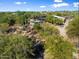 Overhead shot of a desert home nestled amongst mature foliage with a pool, motor court, and ample parking at 25232 N Horseshoe Trl, Scottsdale, AZ 85255
