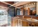 Modern bathroom with a double sink vanity and a glass-enclosed shower at 25232 N Horseshoe Trl, Scottsdale, AZ 85255