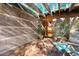 Close-up view of the welcoming front porch with brick flooring, desert plants, and two wooden chairs at 25232 N Horseshoe Trl, Scottsdale, AZ 85255